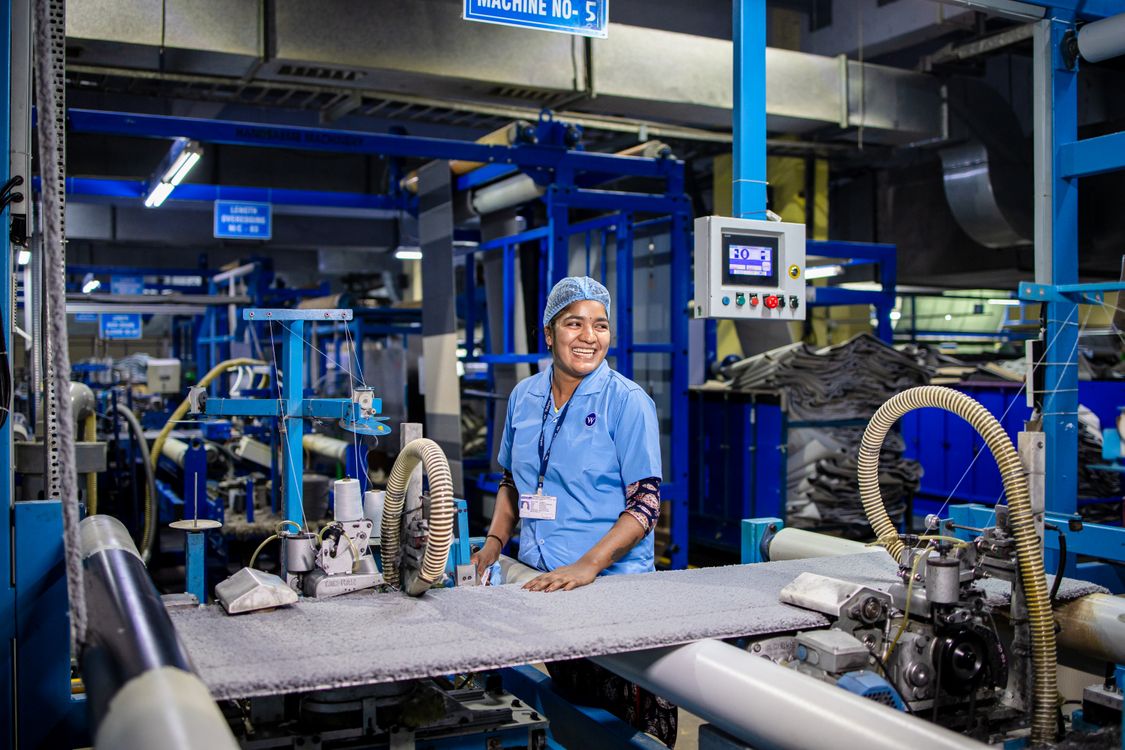 Factory worker operating textile machinery on a production floor - how to stay awake on a 12 hour shift