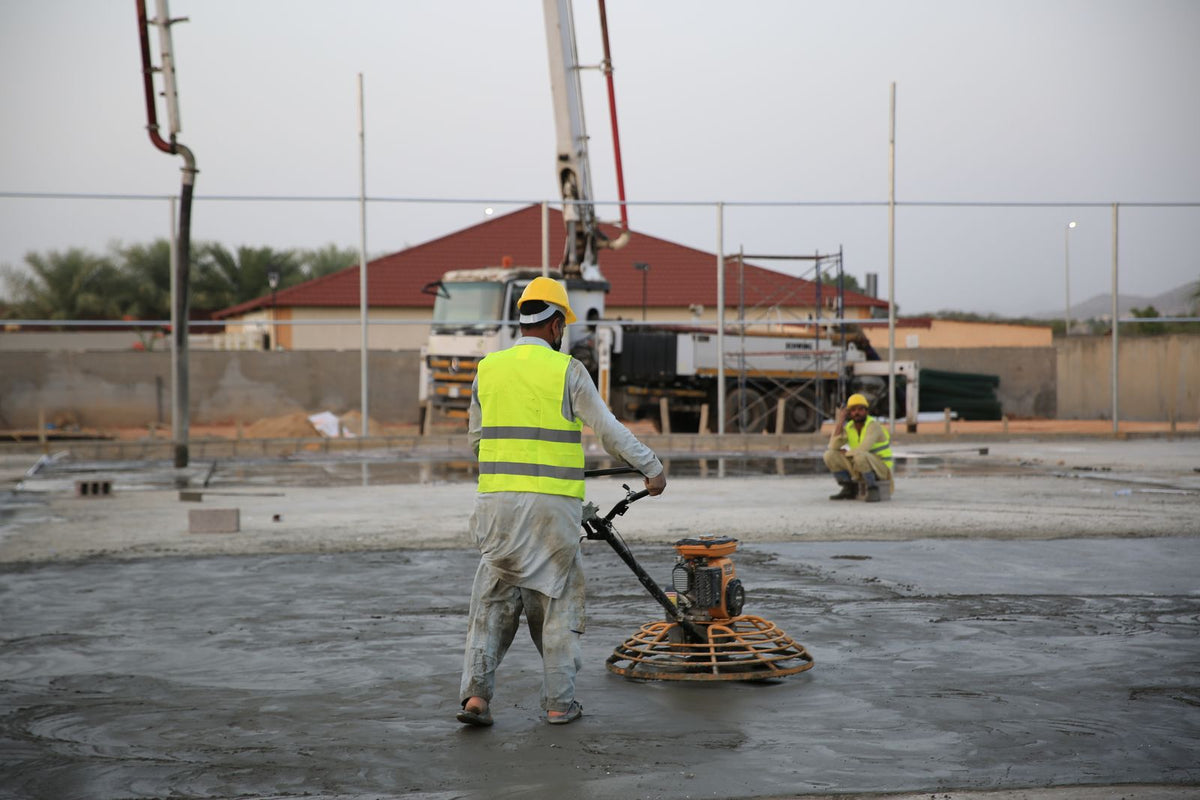 Construction workers smoothing freshly poured concrete on a building site - how to beat afternoon fatigue on a construction site