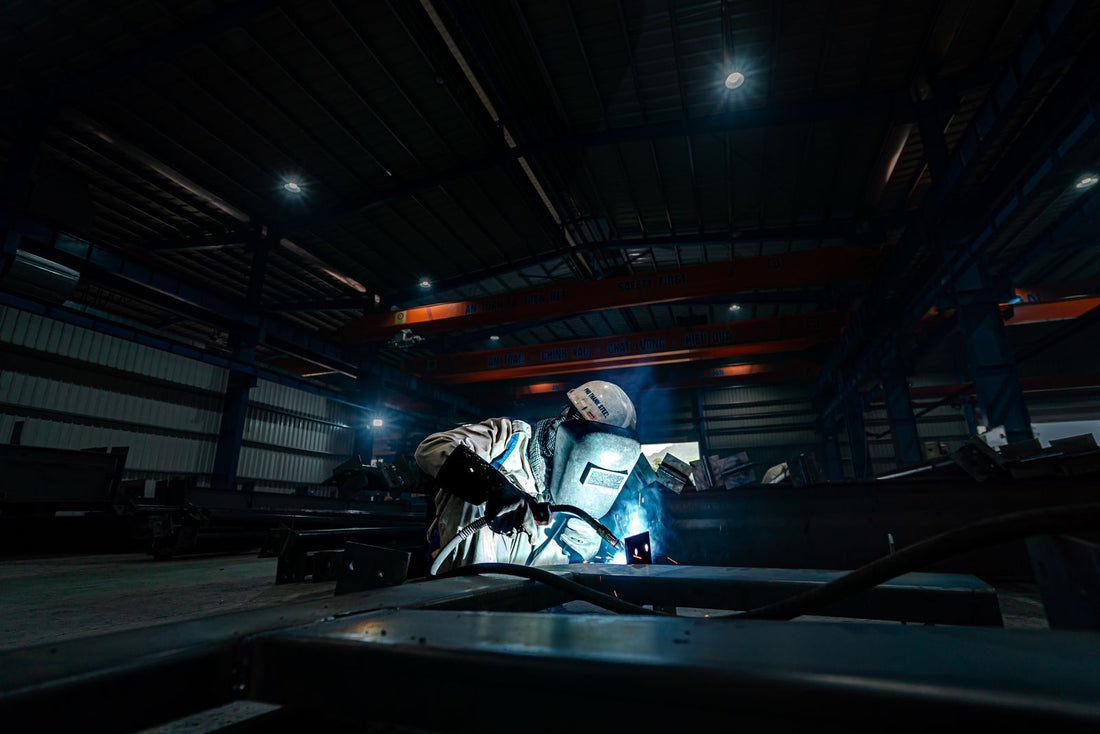 Welder working on a factory floor - energy and focus support for manufacturing workers
