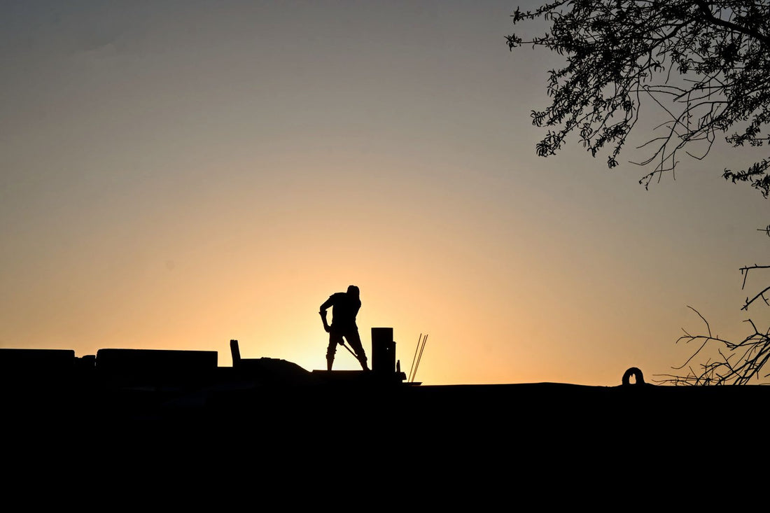 Construction worker silhouetted at sunrise - energy for early starts and physical work