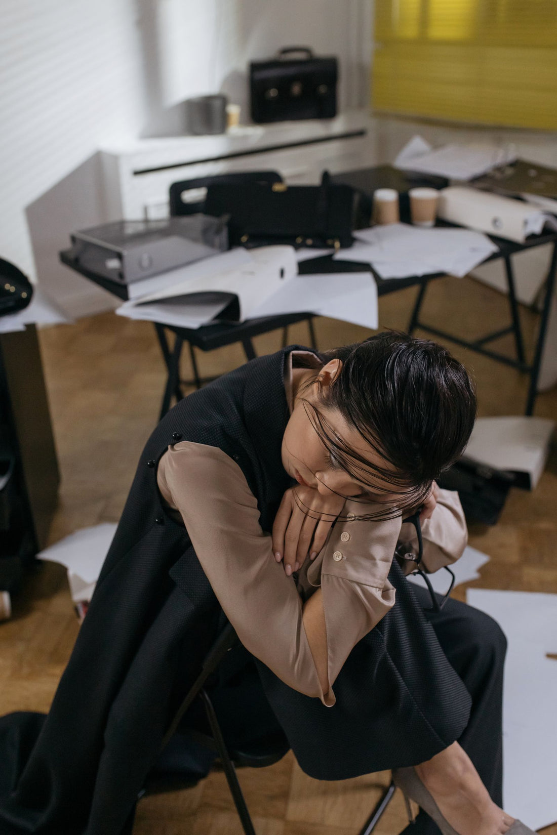 Tired office worker resting at her desk - how to beat the 3 PM slump at work