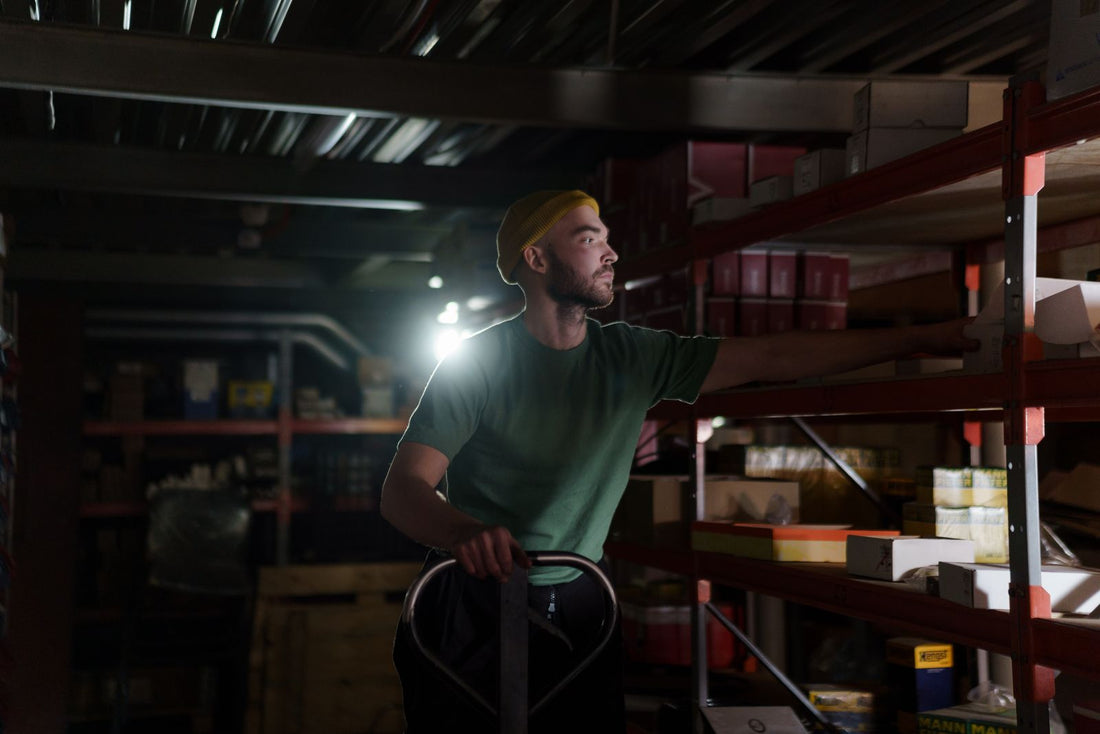 Warehouse worker organizing inventory on shelves during a night shift - how to adjust to night shift