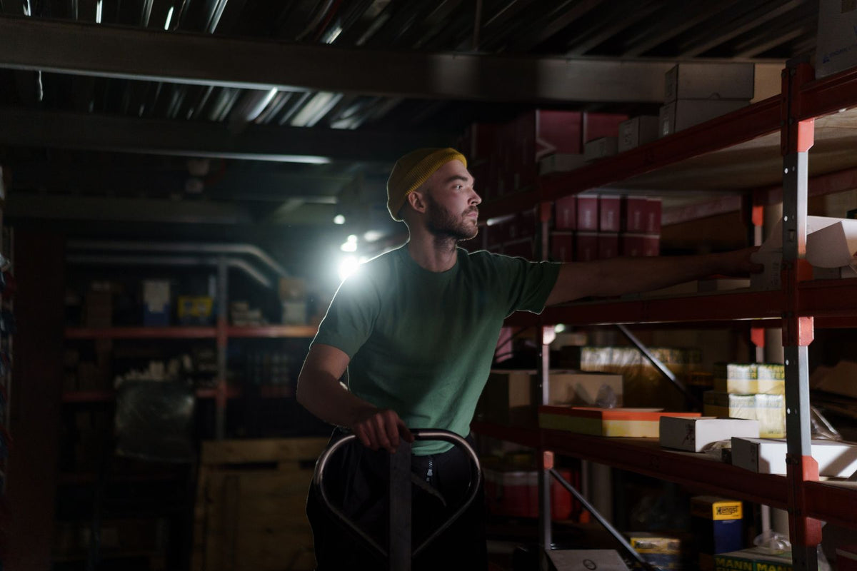 Warehouse worker organizing inventory on shelves during a night shift - how to adjust to night shift